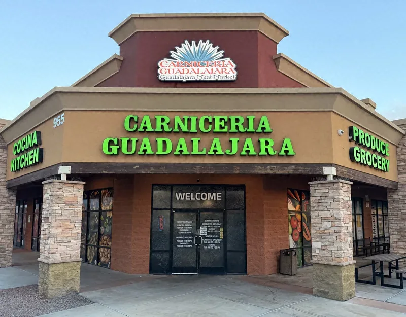 Carniceria Guadalajara storefront in daylight, green sign and WELCOME doors