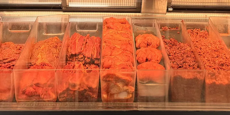 Marinated and prepared meats in the second meat case at Carniceria Guadalajara